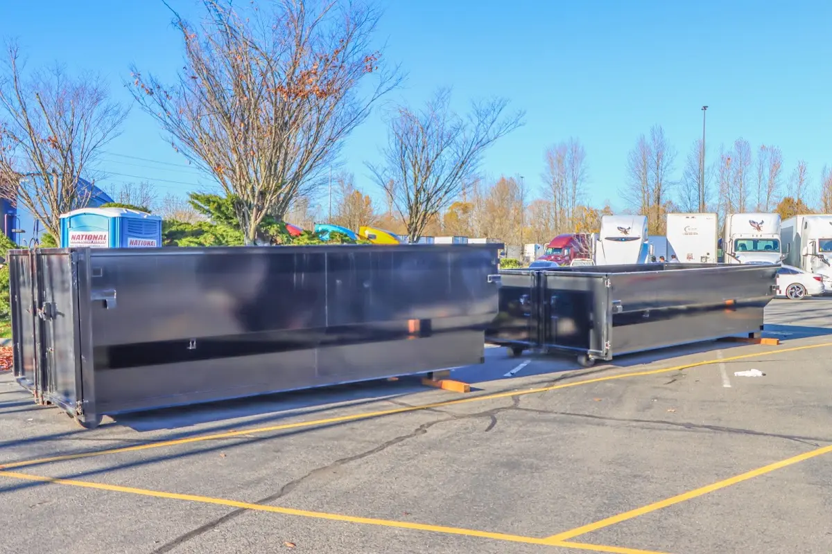 Professional dumpster rental service with roll-off container on residential driveway in Lincoln City